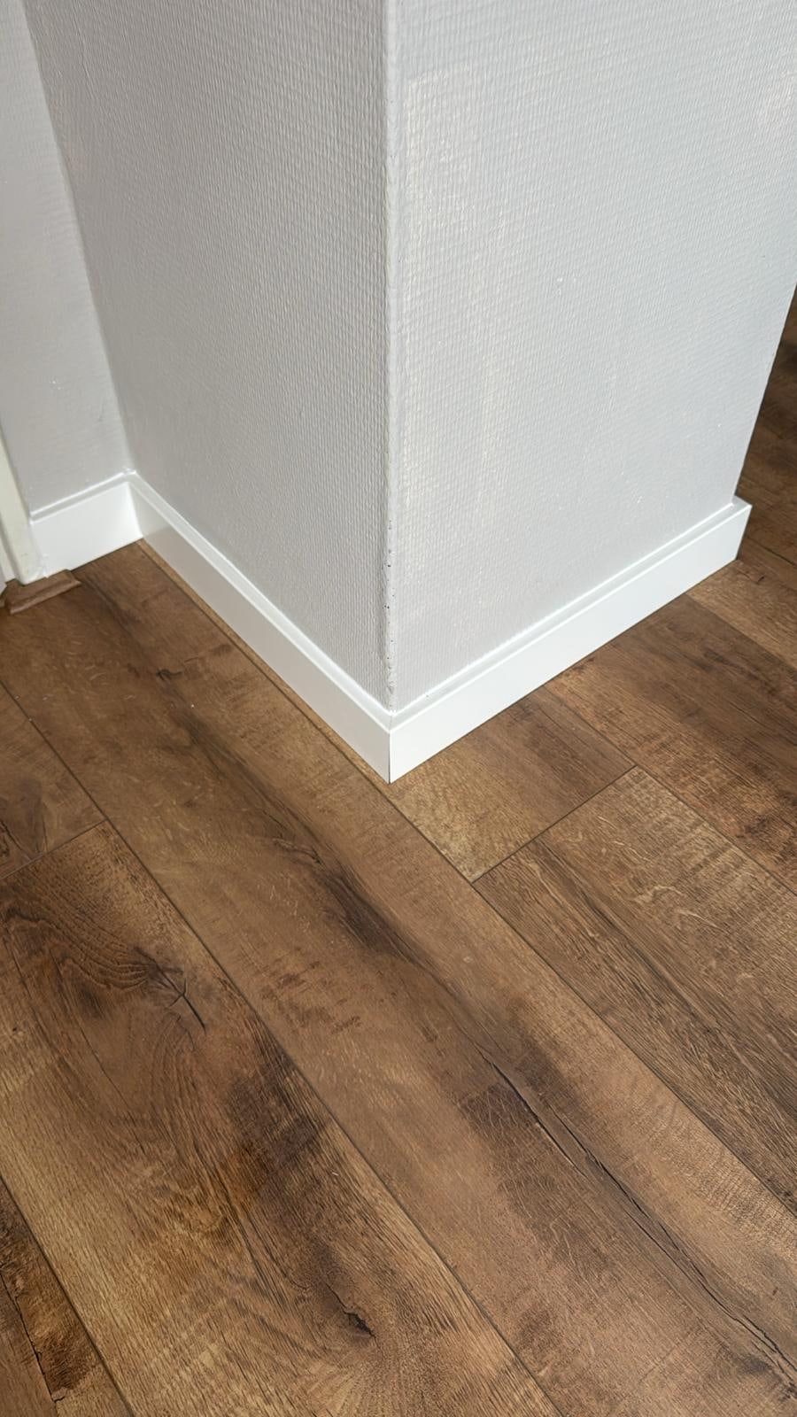 Skirting board against a wall by a finished floor
